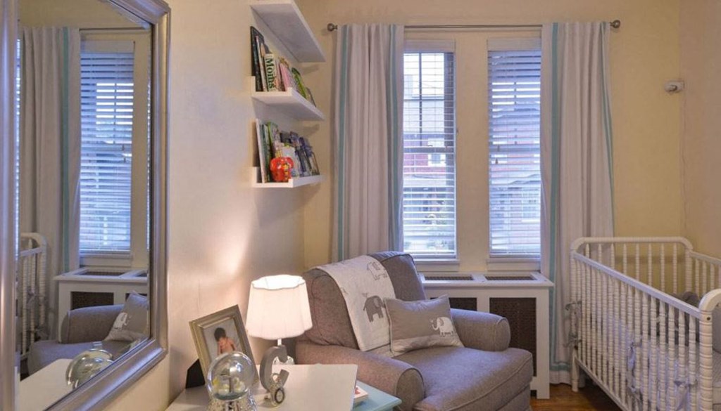 a living room with a couch and a mirror