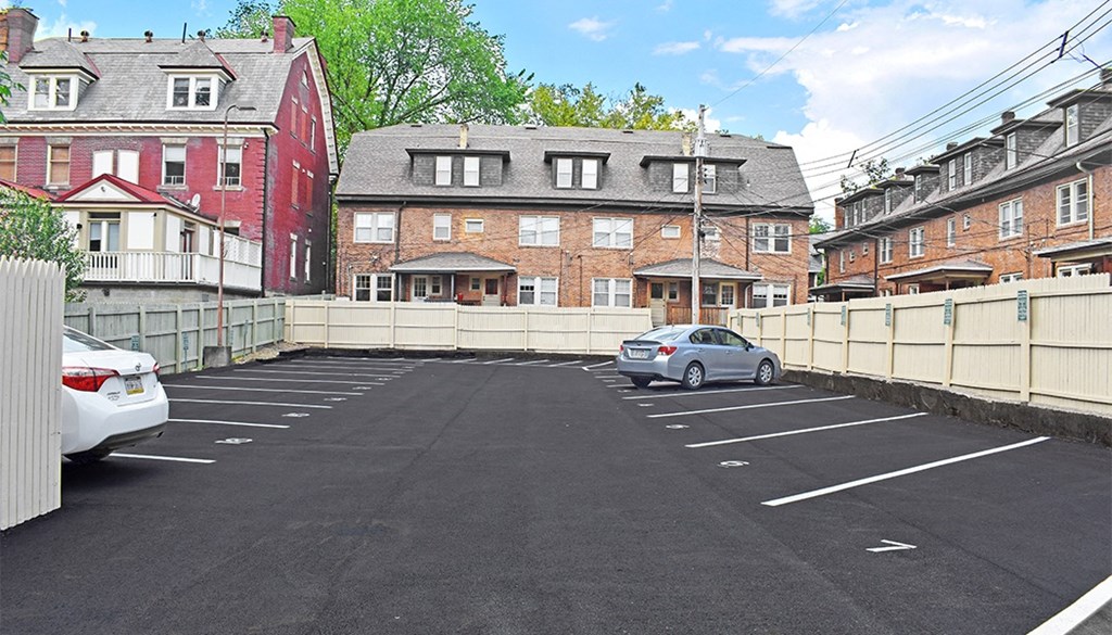 a car parked in a parking lot in front of a brick building