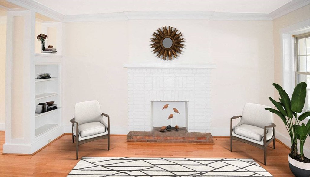 a living room with two chairs and a fireplace