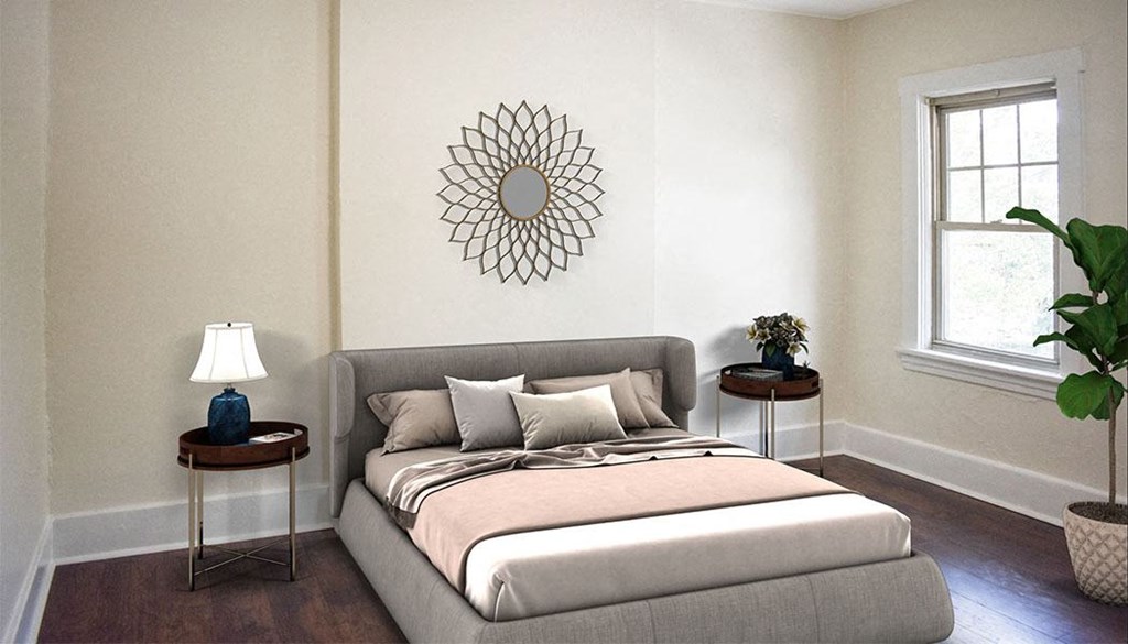 a bedroom with a bed and a mirror on the wall