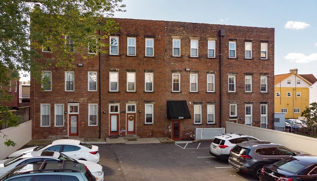 a large brick building with a parking lot in front of it