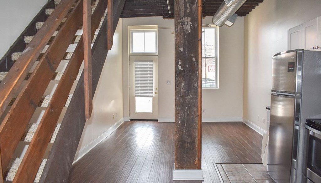 a kitchen with a stove top oven next to a staircase