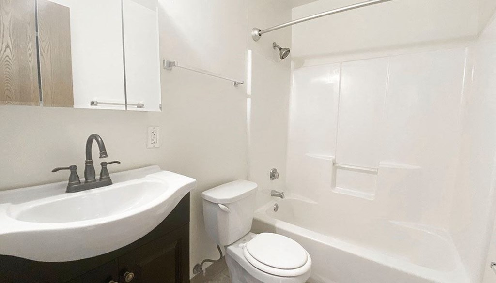 a bathroom with a sink toilet and bathtub