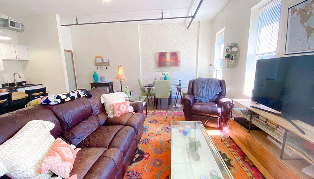 a living room filled with furniture and a flat screen tv