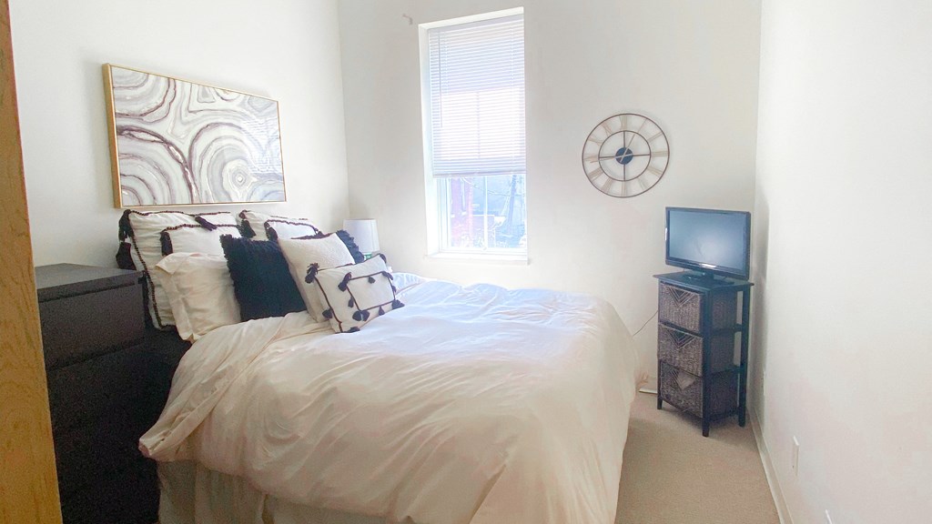 a bedroom with a bed and a tv