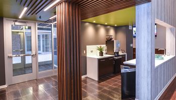 a kitchen with a sink and a refrigerator in a room