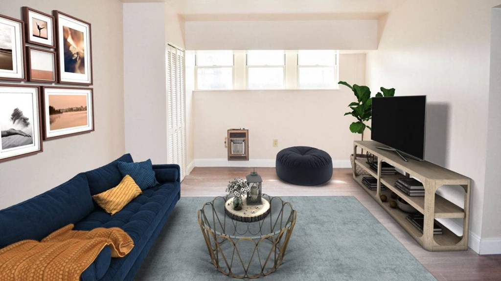a living room with white walls and a blue couch