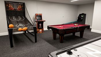 a games room with a pool table shuffleboard and arcade games at The Washington at Chatham, Pittsburgh, PA