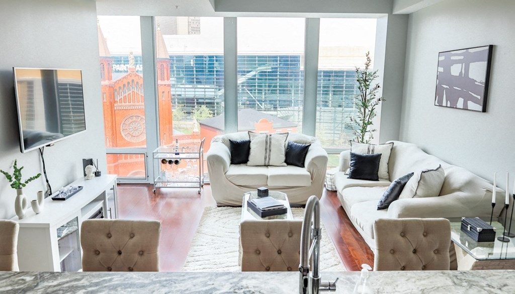 a living room with a white couch and a large window at The Washington at Chatham, Pennsylvania