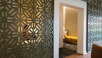a room with a door that has been decorated with a laser cut screen