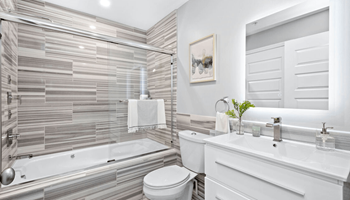 a bathroom with a white toilet next to a bathtub at The Washington at Chatham, Pennsylvania