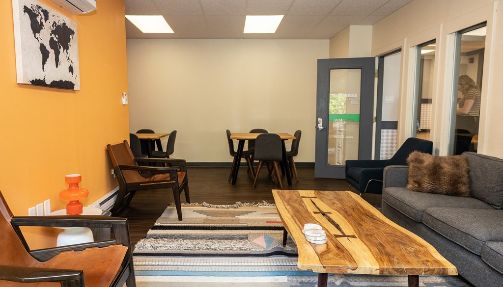 a living room with a couch chairs and a coffee table