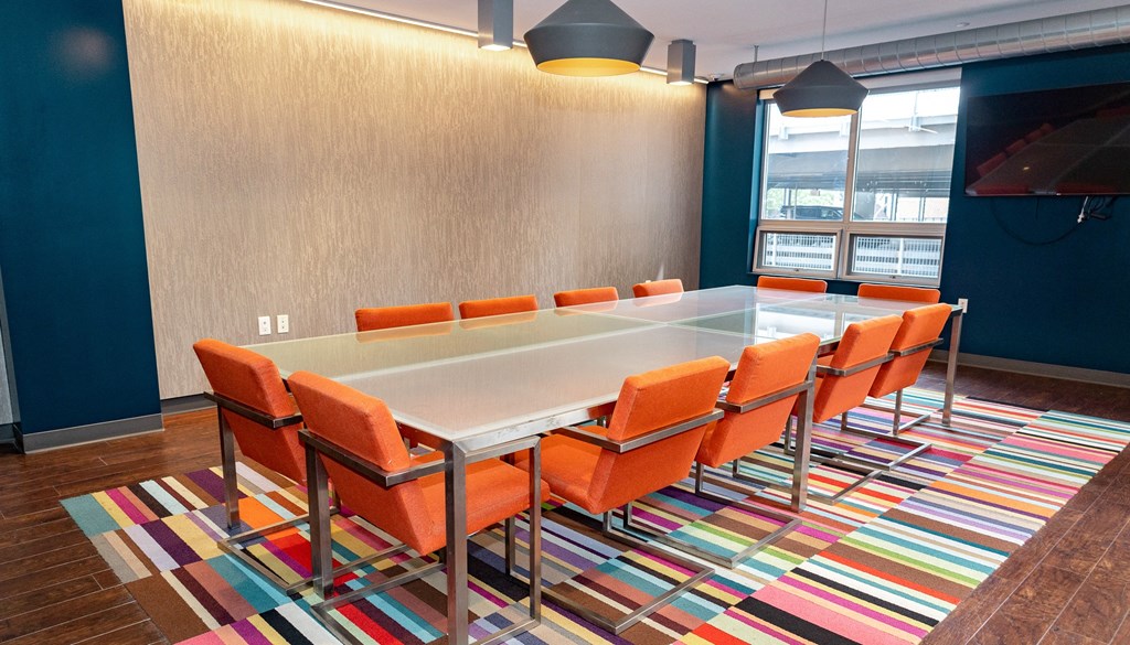 a conference room with a long table and orange chairs at Walnut on Highland, Pittsburgh, PA