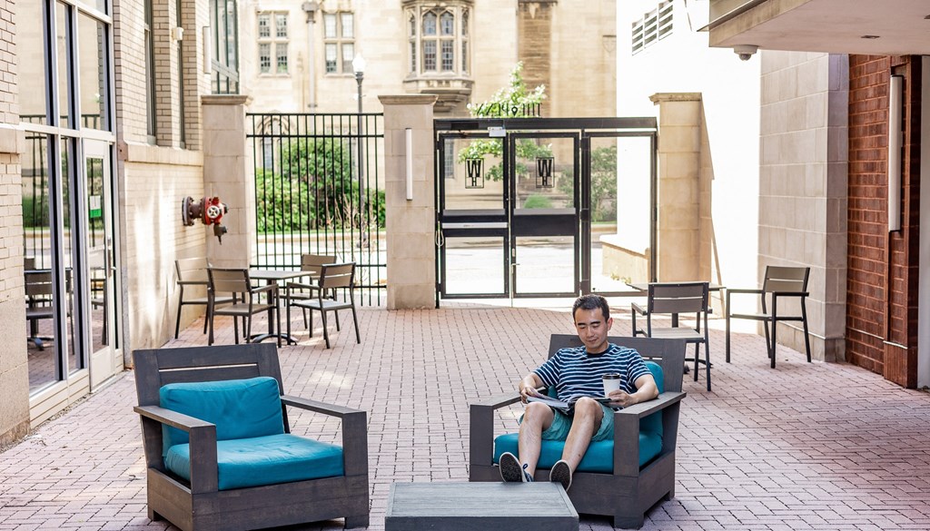 a man sitting in a chair on a patio at Walnut on Highland, Pittsburgh, PA