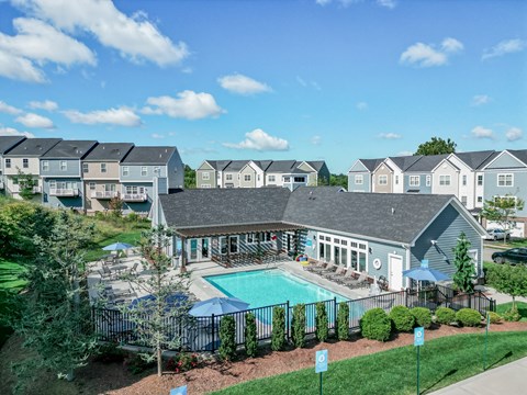 A swimming pool is surrounded by a fence and bushes. at Highland Village, Ross Township, Pittsburgh, PA 15229