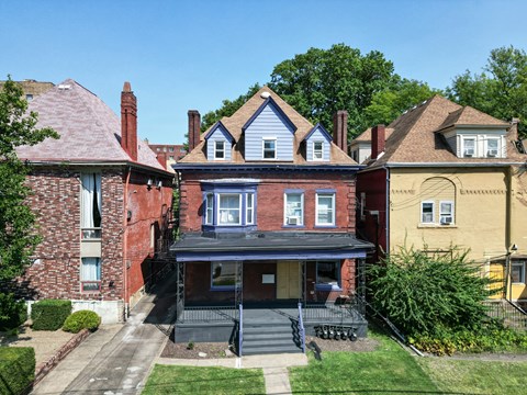 A house with a blue roof and a porch.