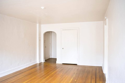 A room with a wooden floor and white walls.