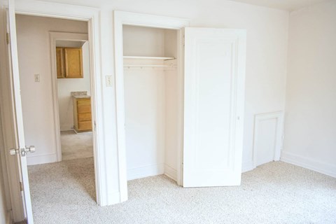 A white room with two open doors.