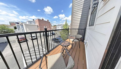 a balcony with a table and two chairs on it