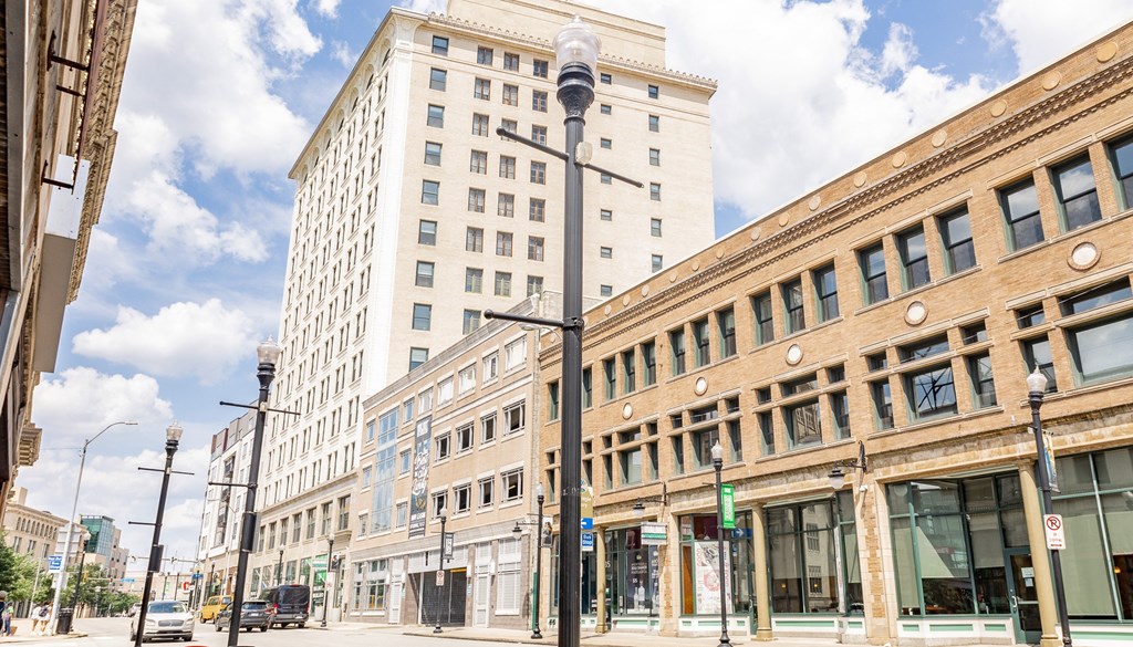 a city block with a tall building in the background and a street lamp in the foreground at Walnut on Highland, Pittsburgh, PA