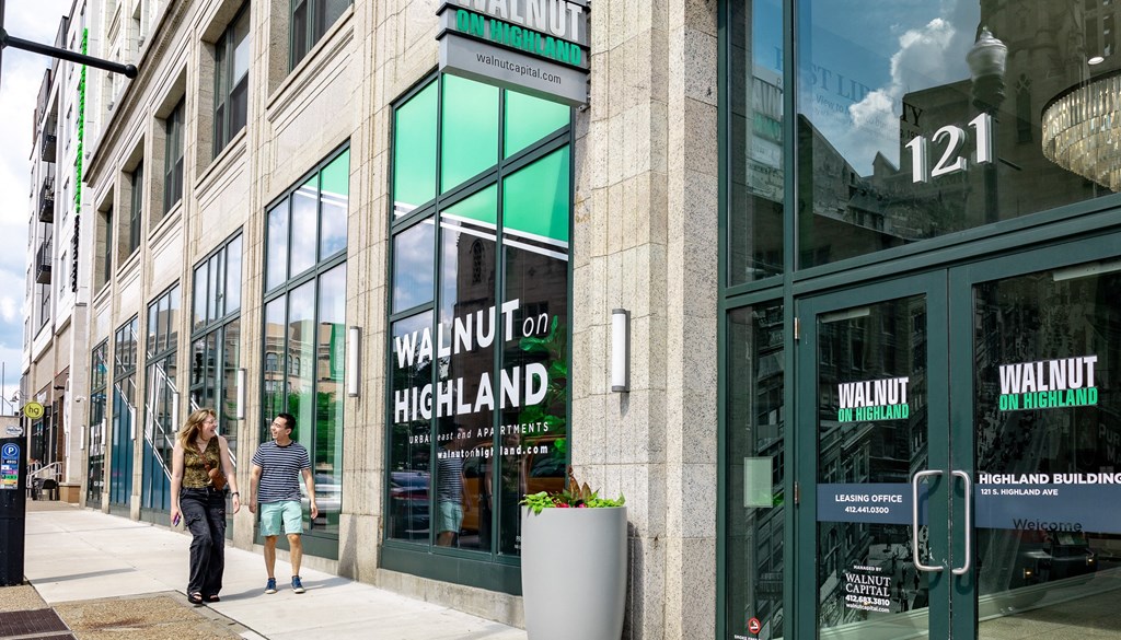 people walking down a sidewalk in front of a building at Walnut on Highland, Pittsburgh, PA