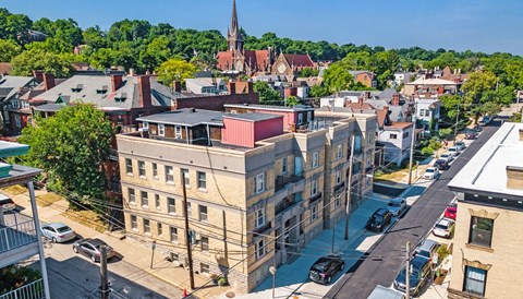 an aerial view of a city with a church in the background