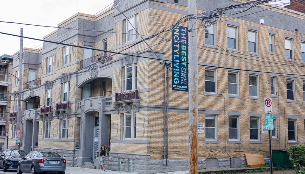 a large brick building with a sign on the side of it