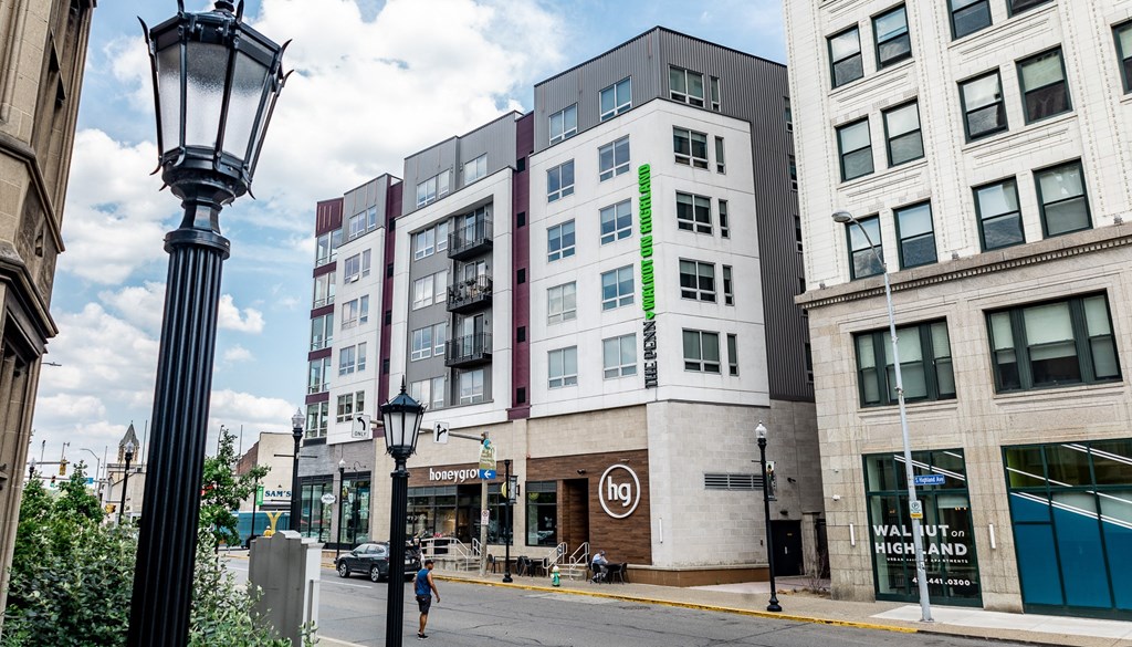 a building with a green neon sign on the side of it at Walnut on Highland, Pittsburgh, PA