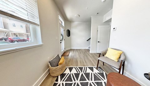 a living room with a couch and a chair next to a window