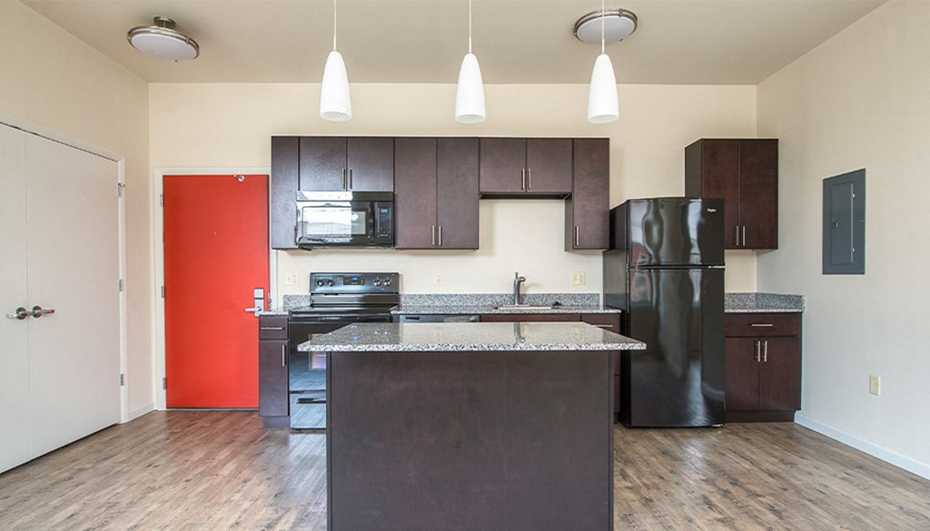 a kitchen with a black refrigerator freezer and a black stove top oven at Walnut on Highland, Pittsburgh, PA