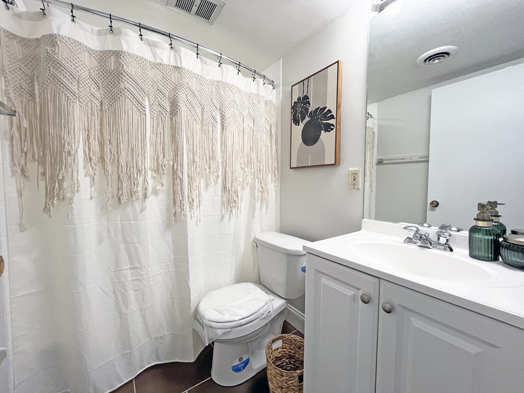 a bathroom with a white sink and toilet and a white shower curtain at Walnut Towers at Frick Park, Pennsylvania 15217