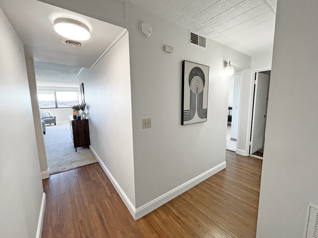 a view of the hallway of an apartment with hardwood floors at Walnut Towers at Frick Park, Pittsburgh, 15217