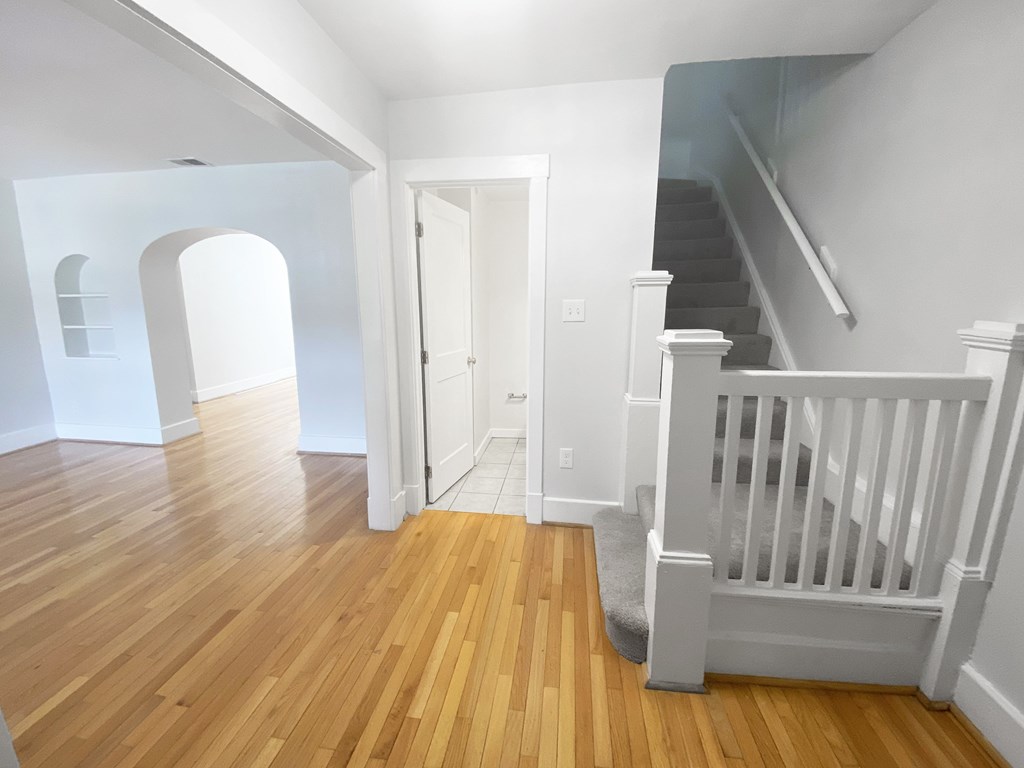 A room with wooden floors and white walls.