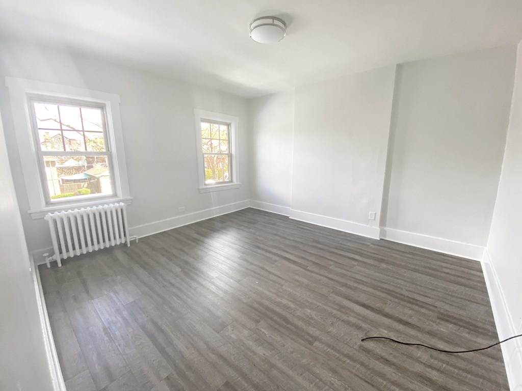 A room with a grey floor and a white wall.