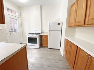 a kitchen with white appliances and wooden cabinets