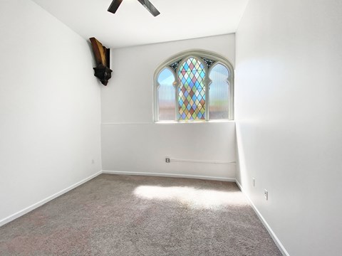 Carpeted Bedroom with Unique Window at University Commons, Pittsburgh 15213