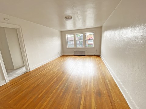 A room with wooden floors and a window.