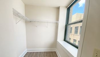 an empty room with a large window and white walls