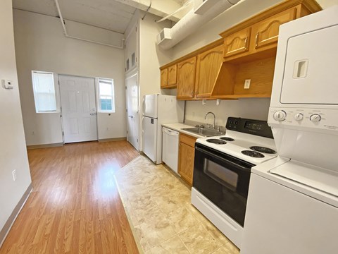 a kitchen with white appliances and wooden cabinets