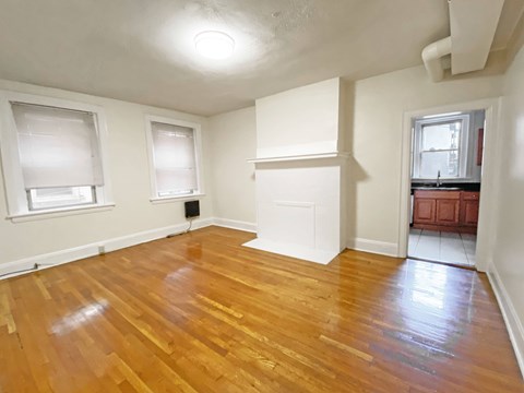 A room with wooden floors and white walls.