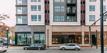 a city street with cars parked in front of a building