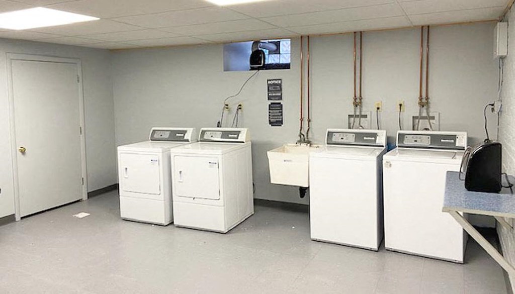 a group of washers and dryers in a room