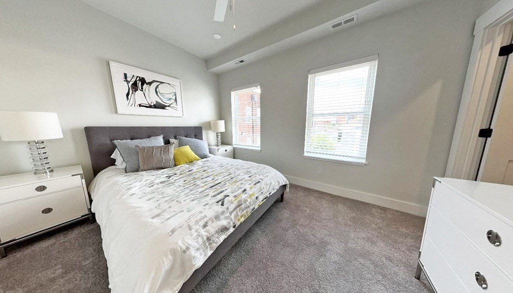 a bedroom with a bed and plants on the walls