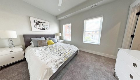 a bedroom with a bed and plants on the walls