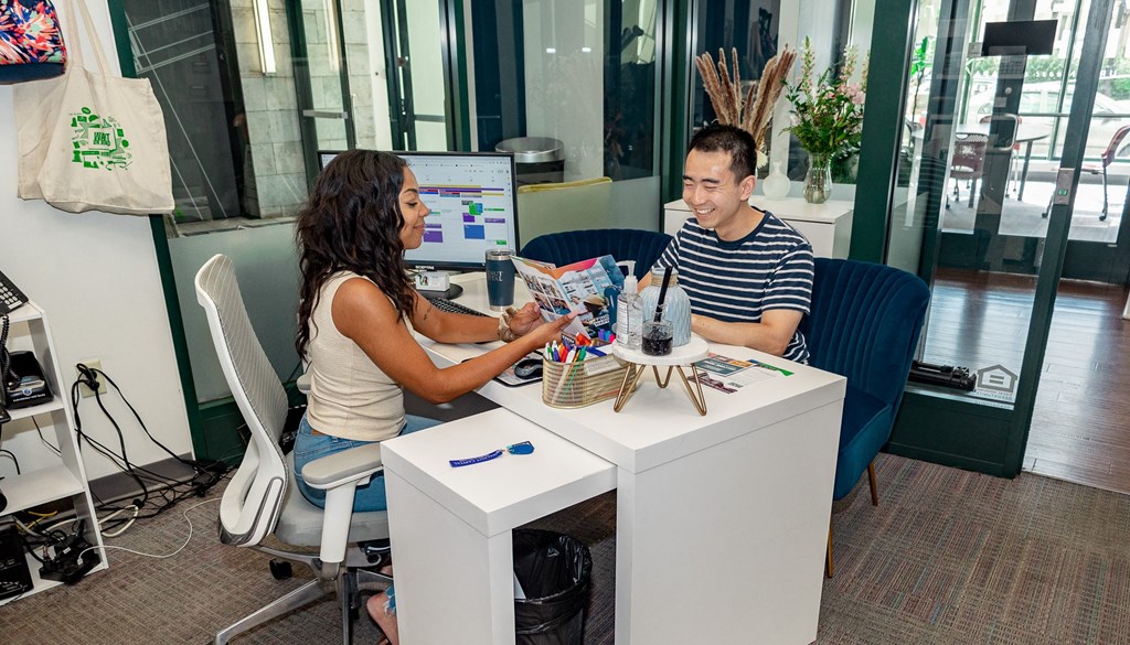 a man and a woman sitting at a desk in front of a computer at Walnut on Highland, Pennsylvania 15206