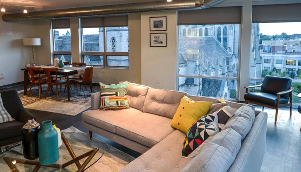 a living room filled with furniture and a large window at Walnut on Highland, Pittsburgh, PA