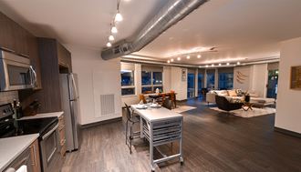 a kitchen and living room in a 555 waverly unit - Photo Gallery 3