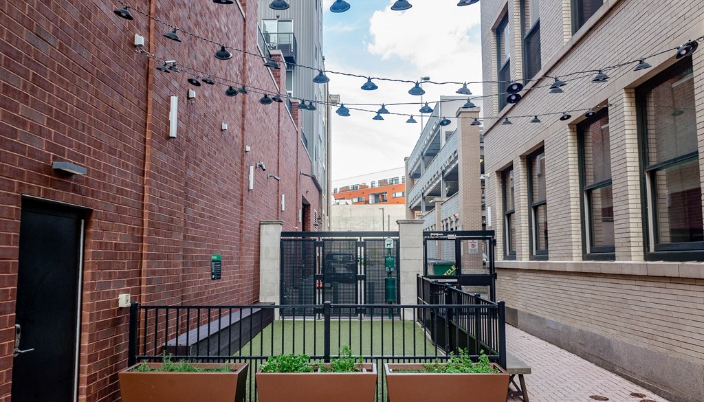 a courtyard with a grassy area and a black gate at Walnut on Highland, Pittsburgh, PA