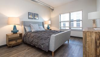 a bedroom with a bed and two windows - Photo Gallery