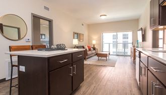 a kitchen and living room with a sliding glass door to a balcony - Photo Gallery
